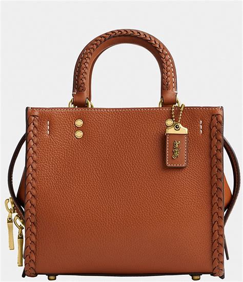 A bit larger than the petite 17, the compact 20 features three organized compartments and detachable straps for shoulder or crossbody wear. . Coach rogue 20